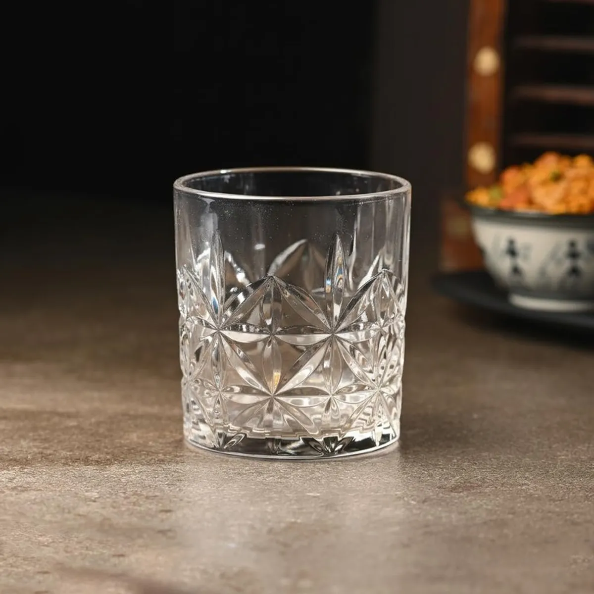 Single clear whiskey glass with geometric textured pattern