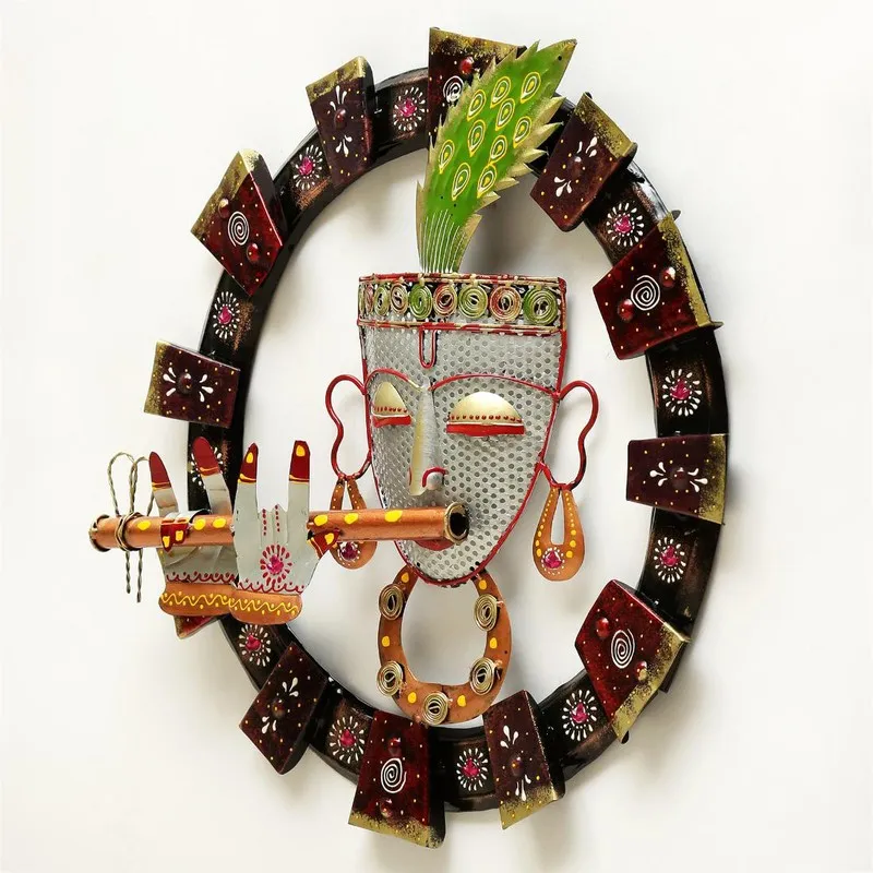 Three-quarter view of the round metal wall accent with decorative face and circular frame