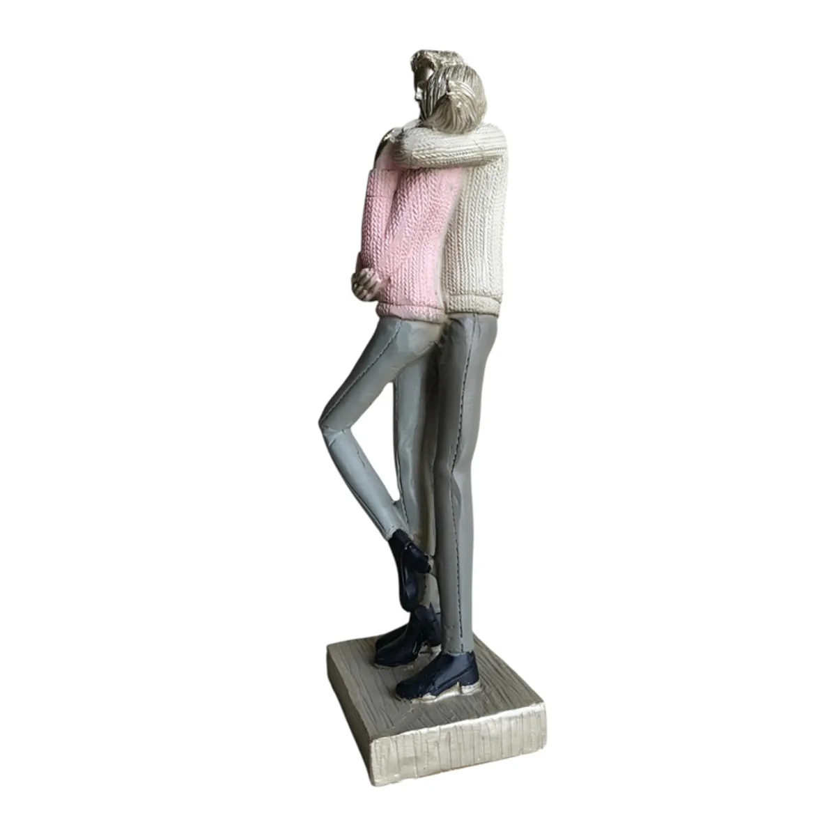 Rear three-quarter view of couple figurine on a square base