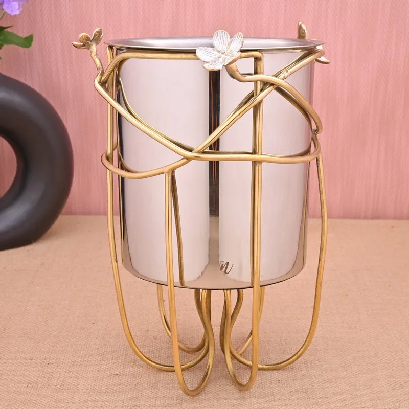 Silver and gold floral ice bucket styled on a tabletop