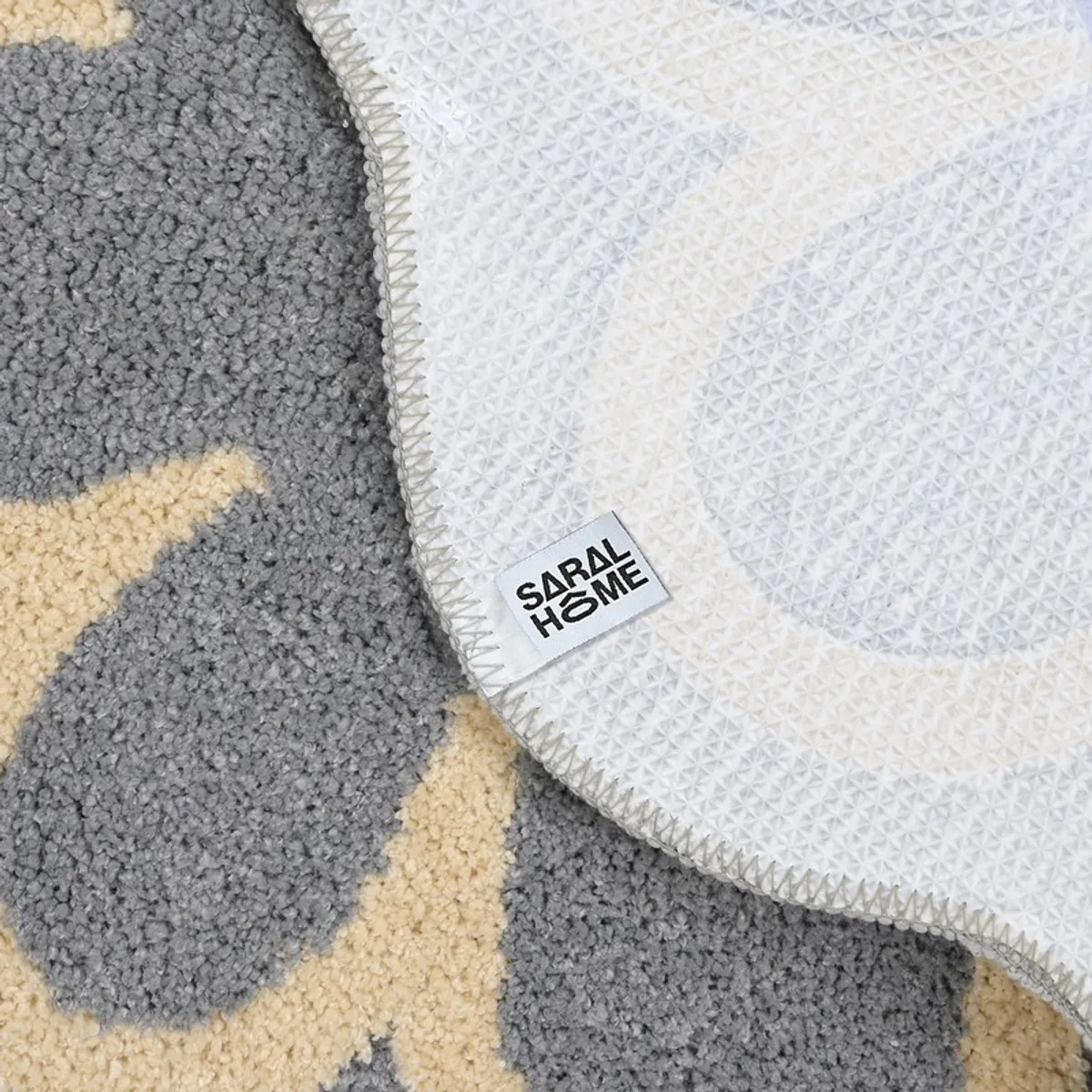 Underside of the flower-shaped bath mat showing its white textured anti-slip backing.