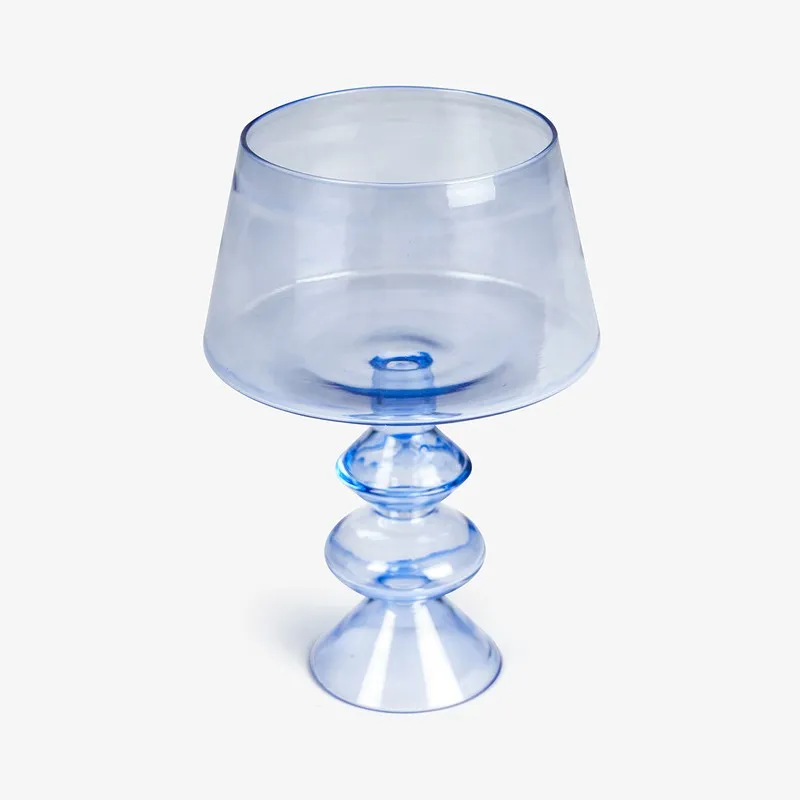 Front view of a translucent blue glass candle holder on a white background