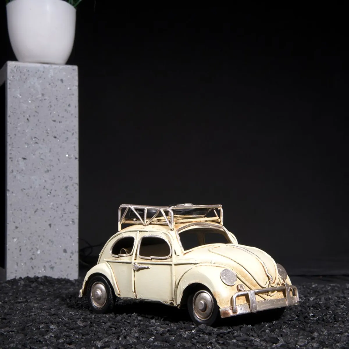 White vintage car tabletop showpiece against a dark backdrop