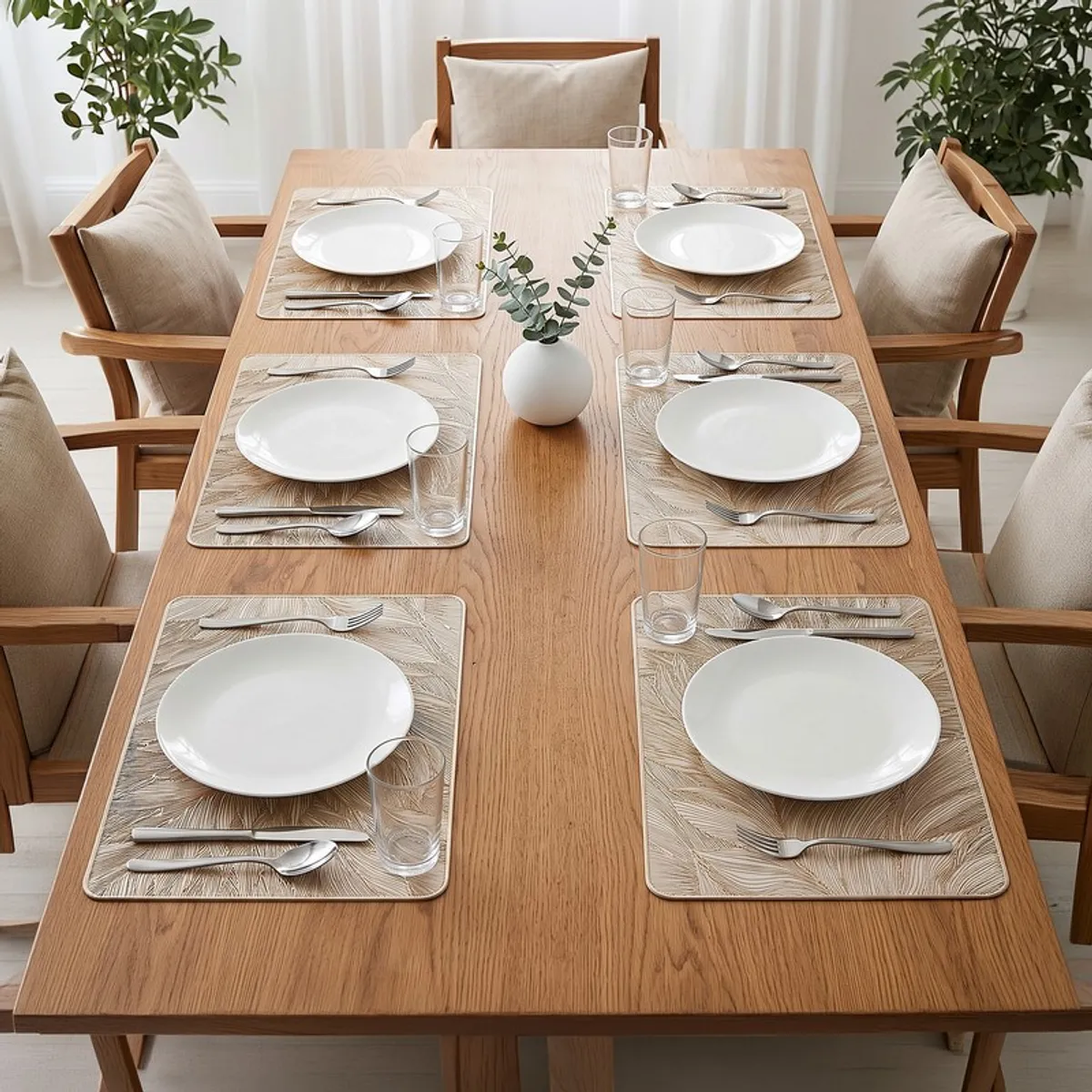 Six feather-pattern rectangular table mats arranged on a wooden dining table