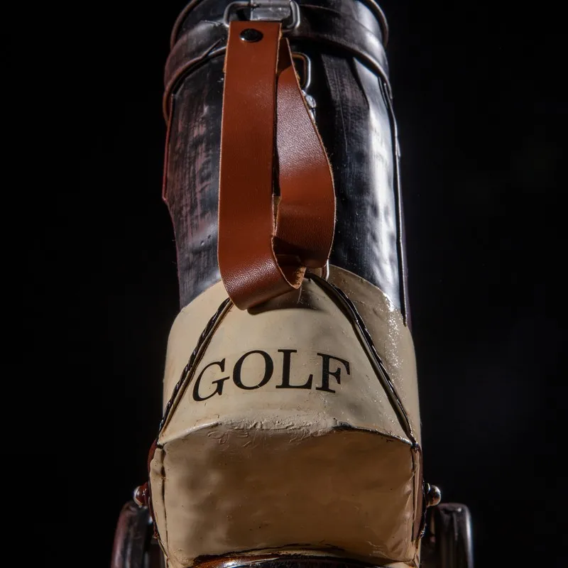 Front view of brown and ivory golf kit miniature showpiece