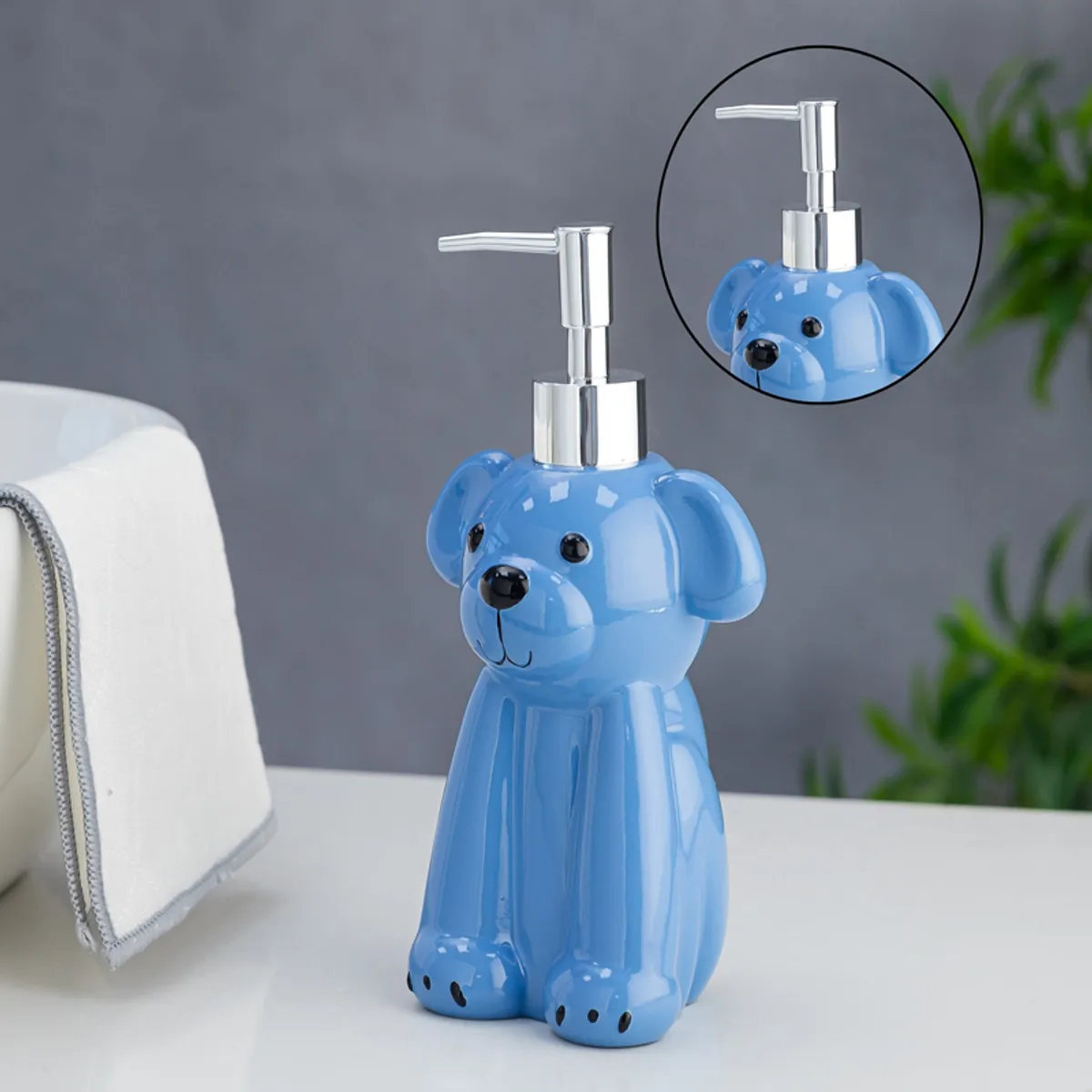 Close view of blue dog-shaped liquid dispenser with silver pump