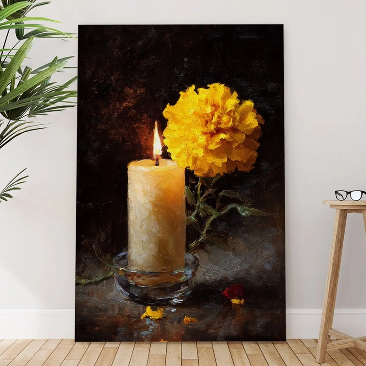 Vertical canvas wall painting with candle and marigold artwork leaning against a wall