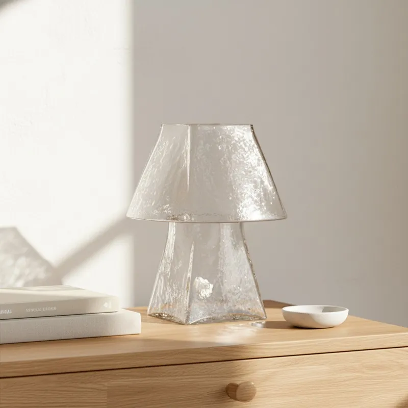 Clear textured glass table lamp on a wooden table in daylight