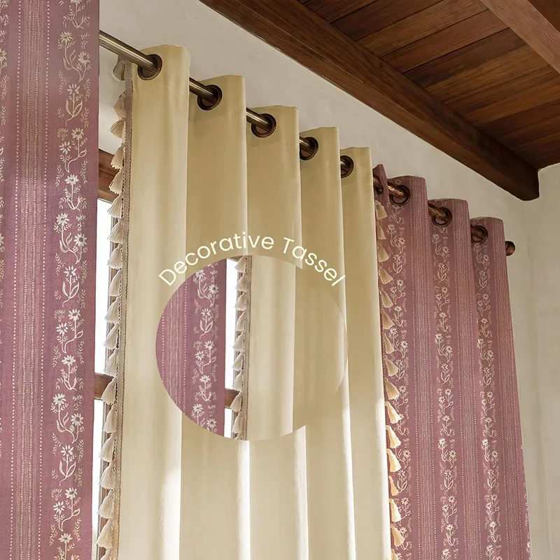 Eyelet curtains in pink and off-white with tasselled edge detailing