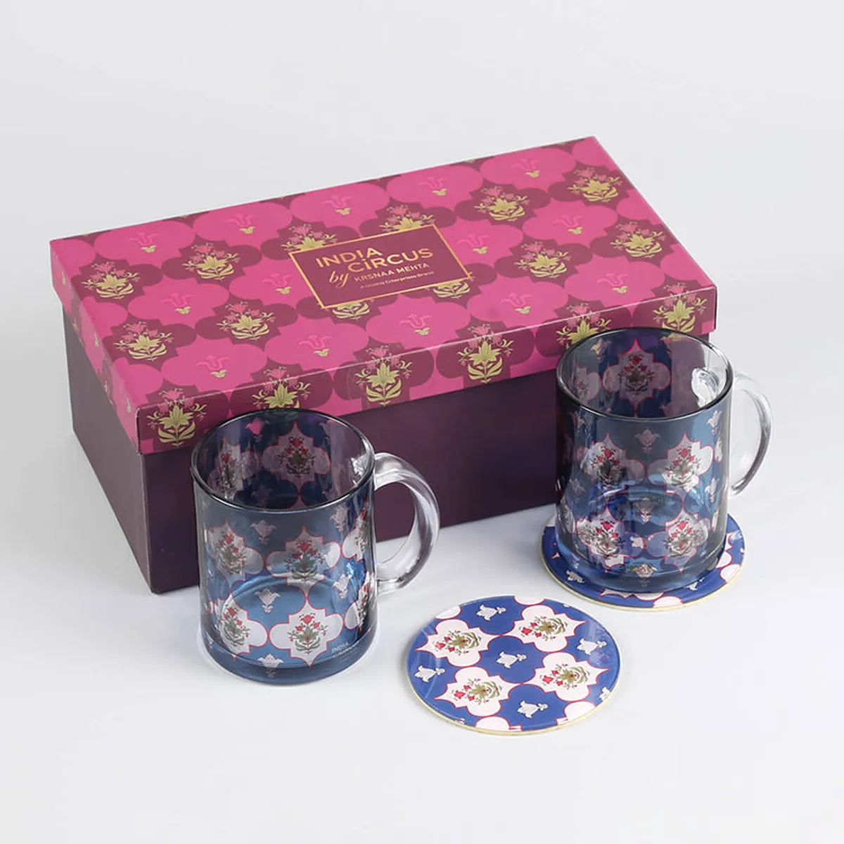 Two blue floral glass mugs and coasters shown with a gift box