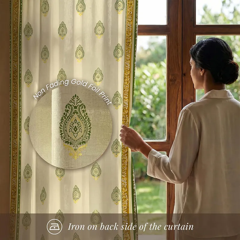 Printed curtain with sage green motifs and border shown beside a window