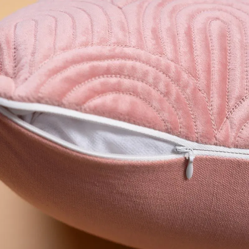 Close-up view of the pink cushion cover's textured surface