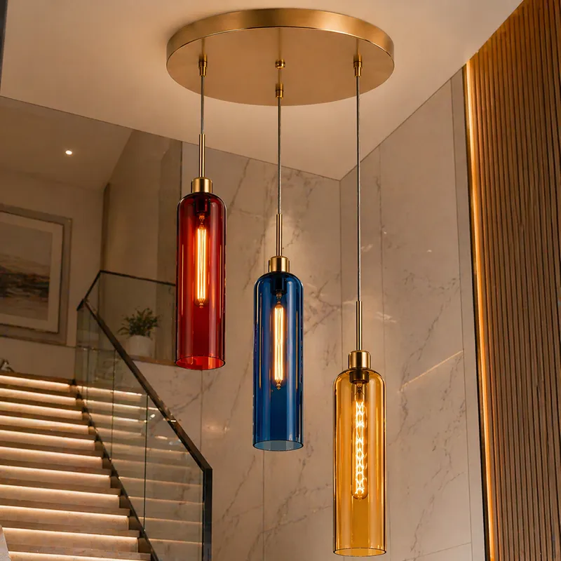 Three-light hanging lamp with coloured glass cylinder shades in a staircase setting