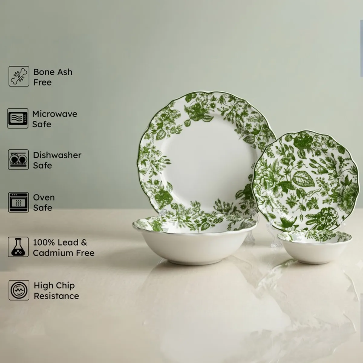 Green and white floral porcelain plates and bowls displayed upright