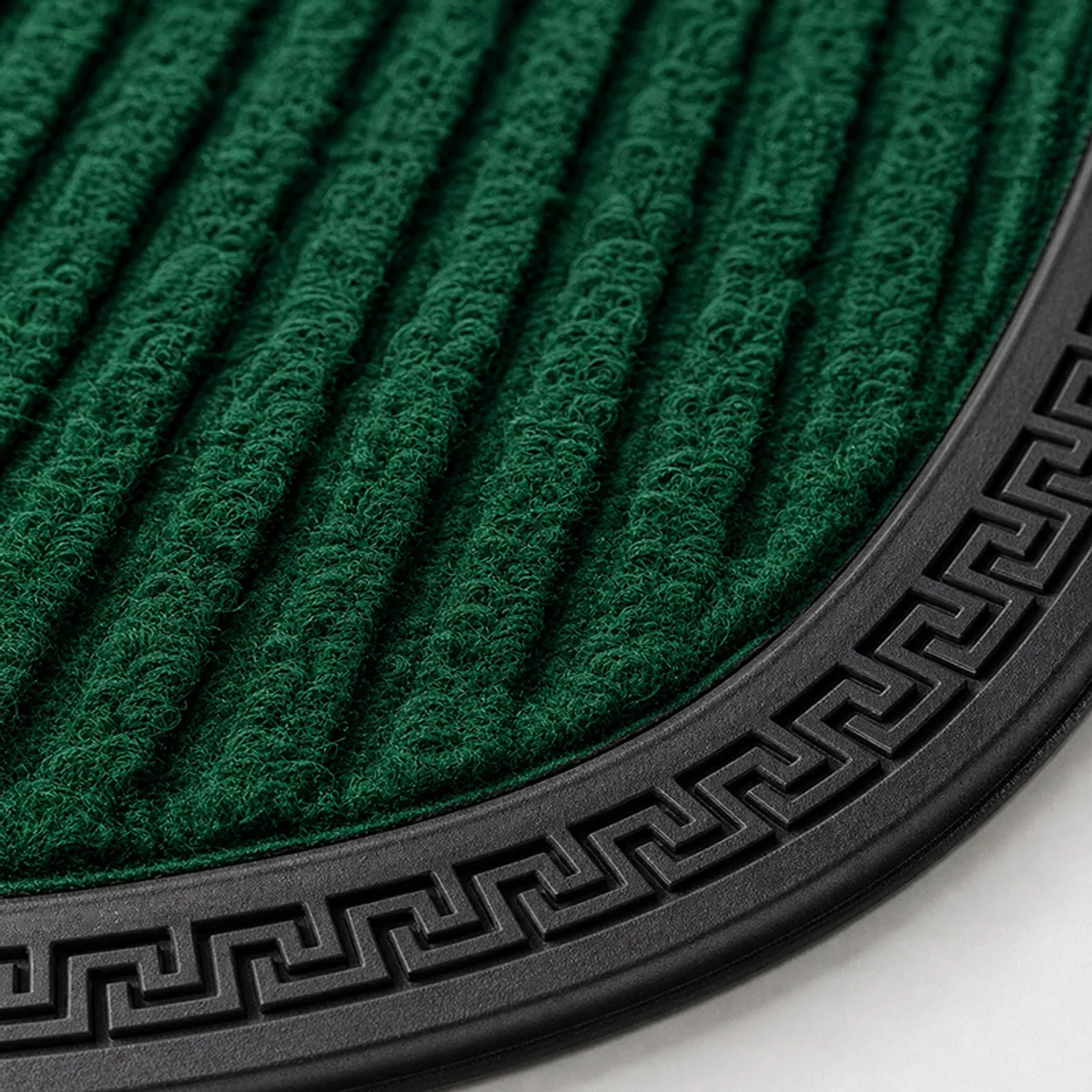 Close-up of the green ribbed mat surface and black geometric border