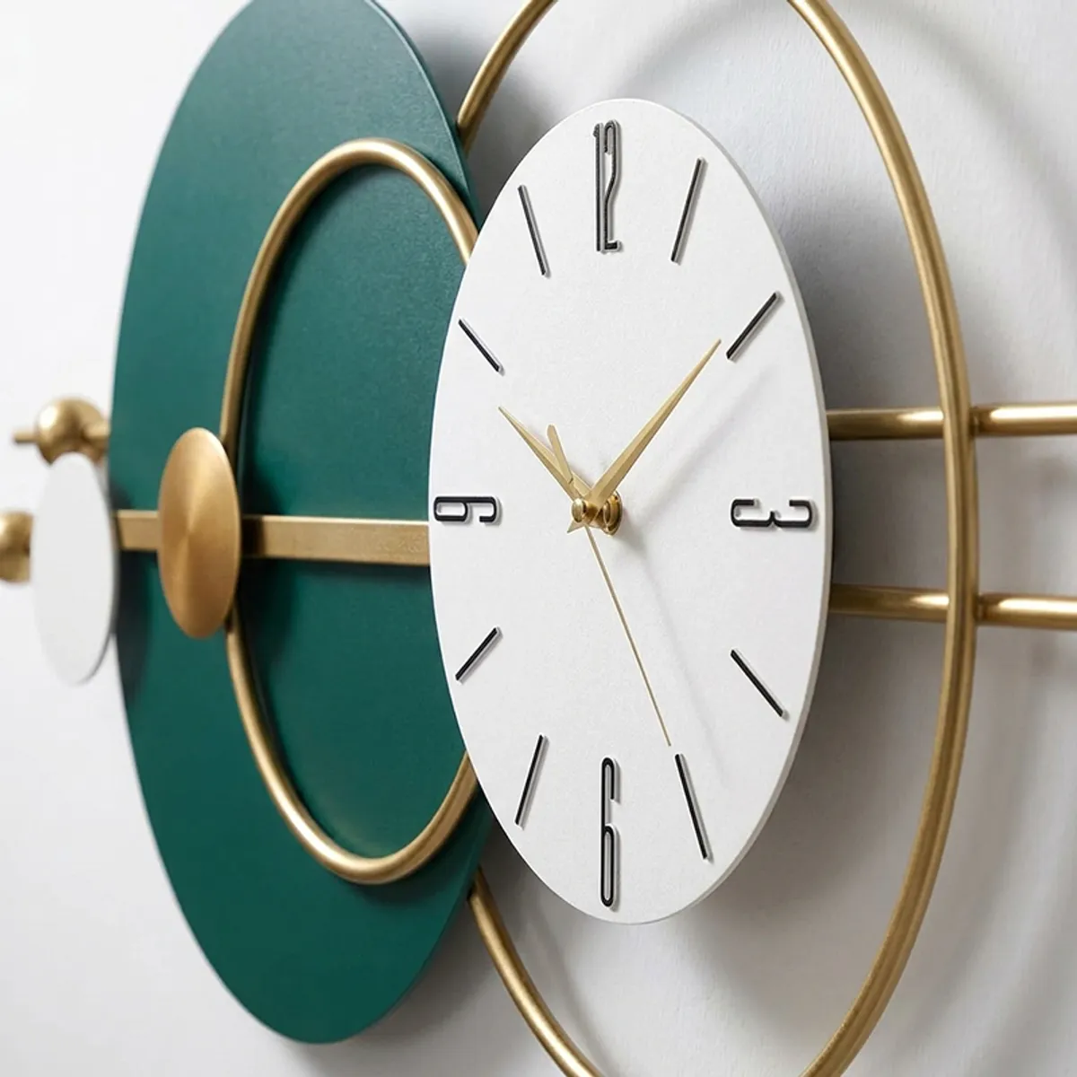 Close-up of the white clock face with gold hands and gold ring detail