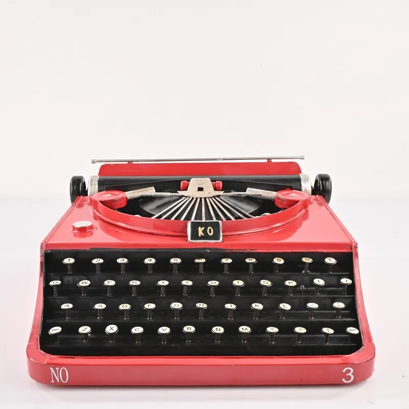 Front view of the red tabletop typewriter showpiece on white background
