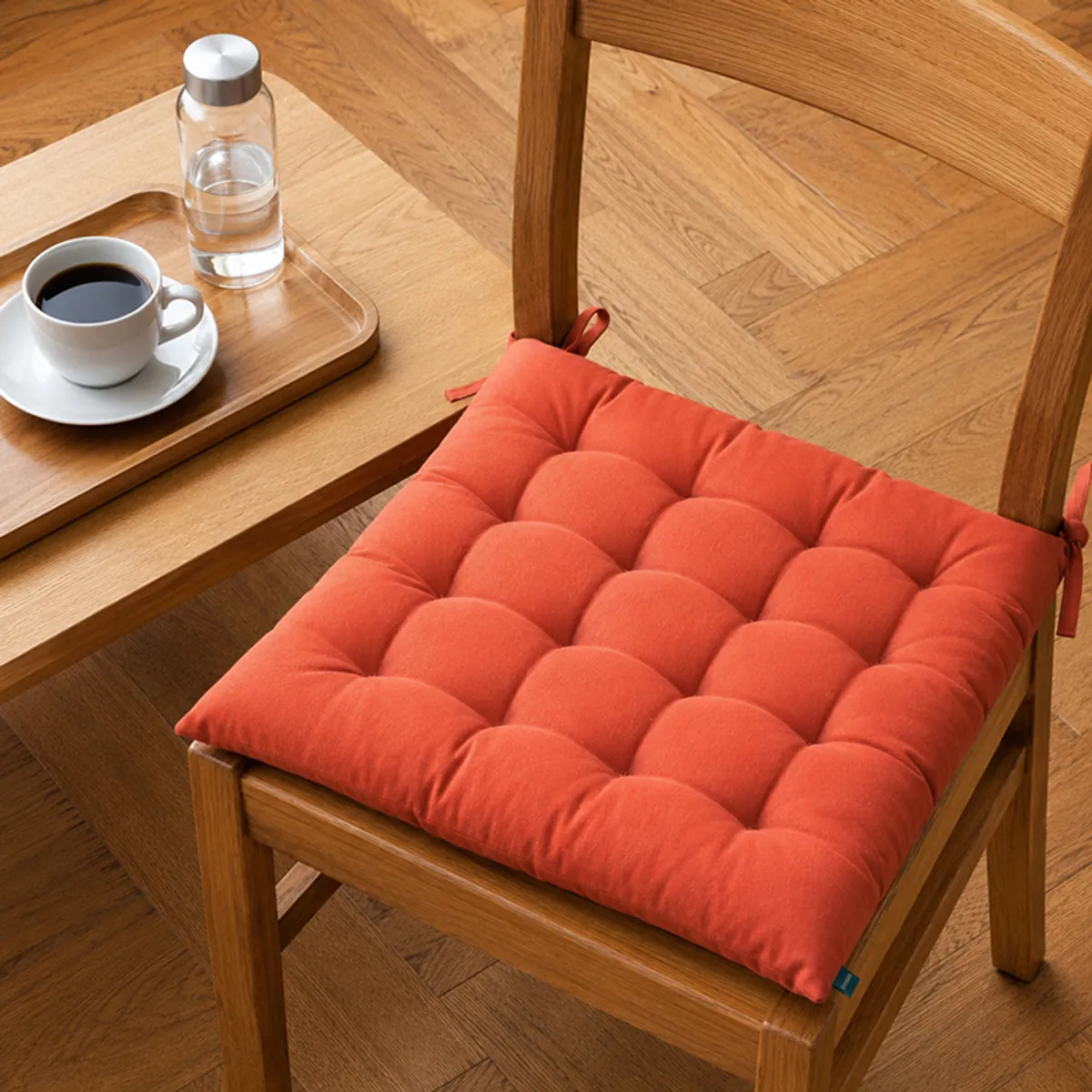 Stack of chair pads in multiple colours including orange, blue, pink and green