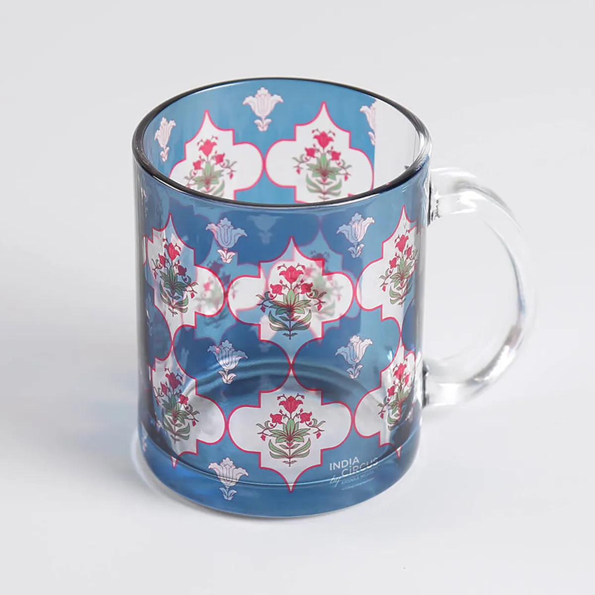 Close-up of a blue floral glass mug with a transparent handle