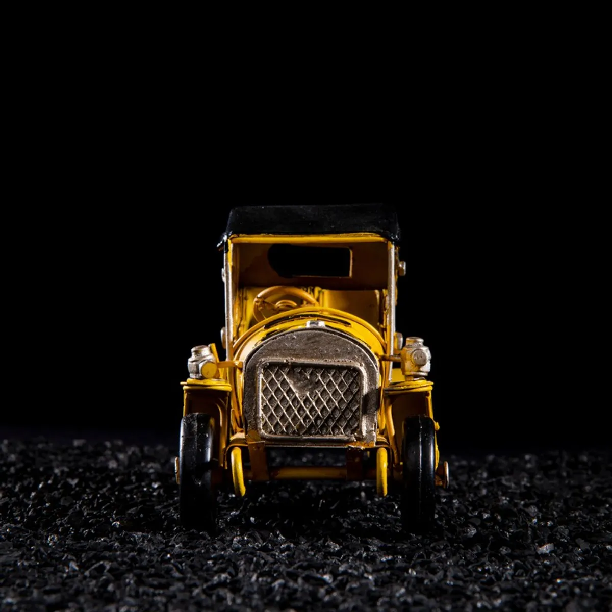 Front view of yellow retro vehicle showpiece with silver grille