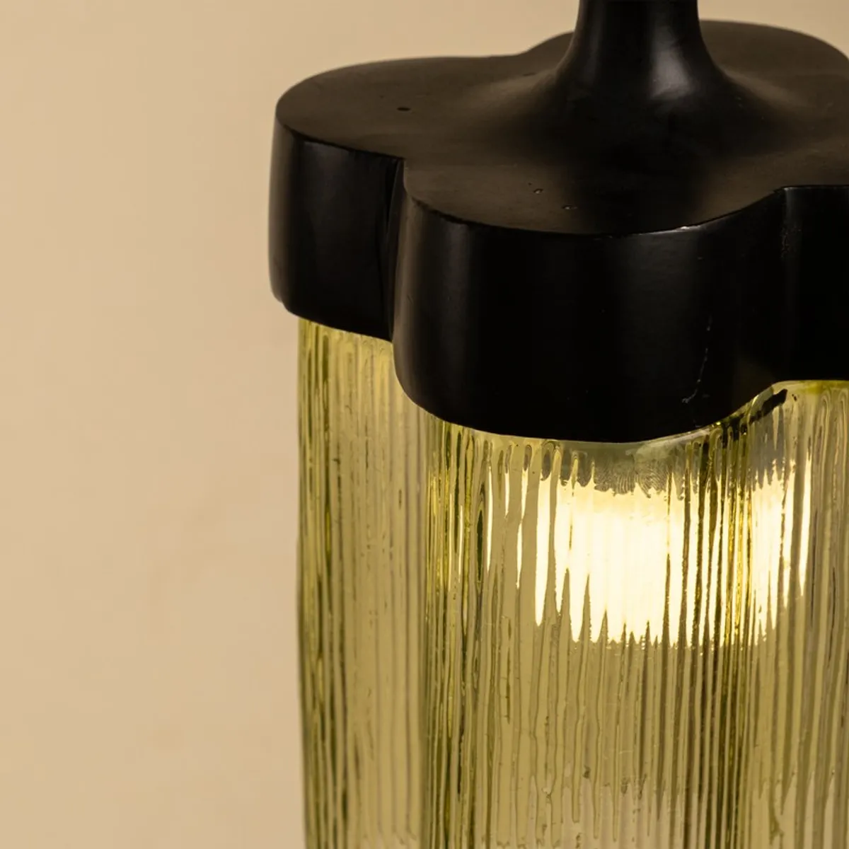 Close-up of illuminated green glass ceiling lamp shade