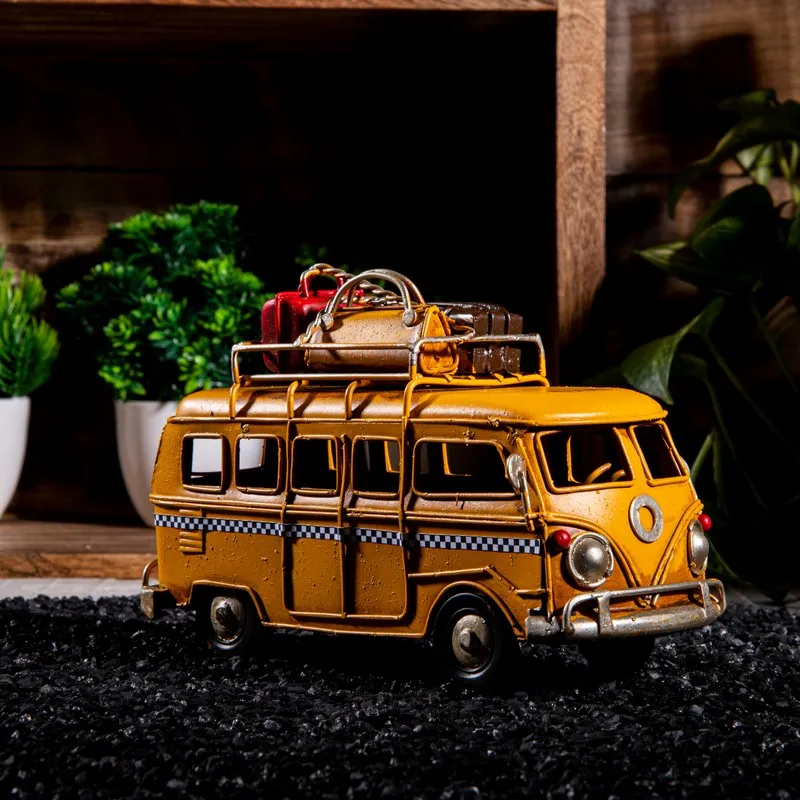 Side view of yellow caravan showpiece with rooftop luggage