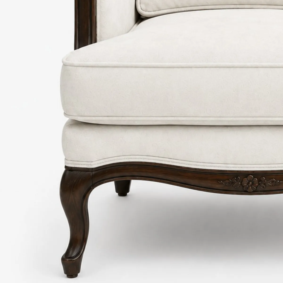 Close-up of the white seat cushion and carved dark wooden base