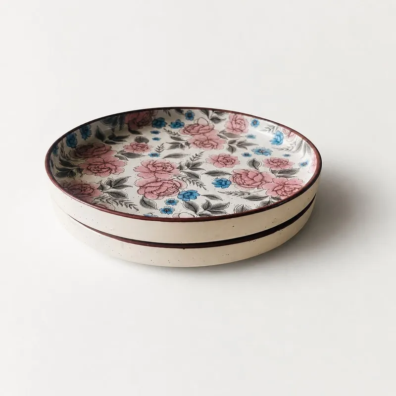 Stacked ceramic dinner plates with multicolour detailing and brown rim
