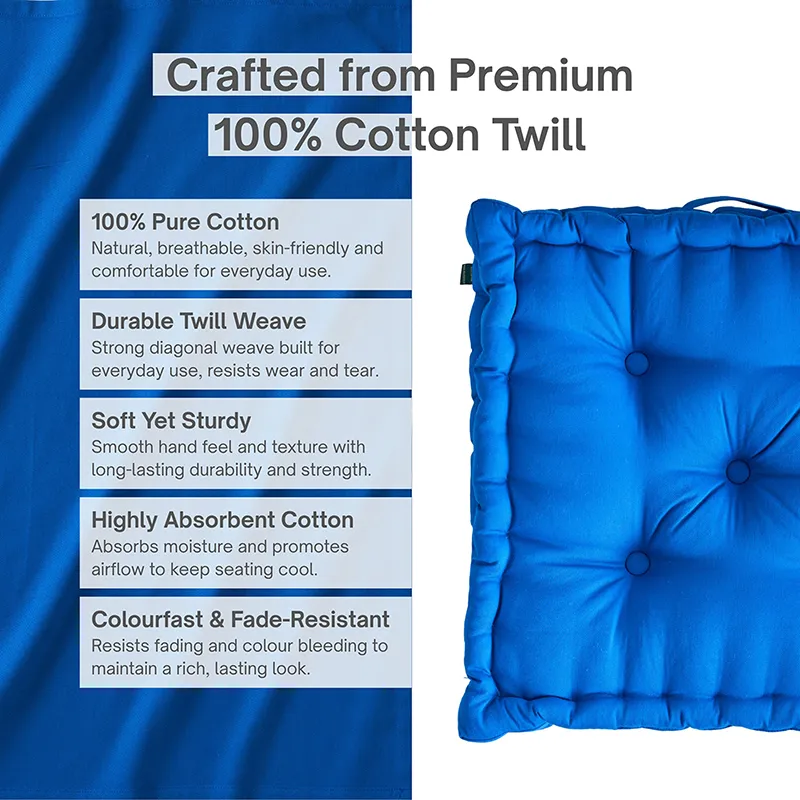 Close view of a classic blue square floor cushion with tufted surface