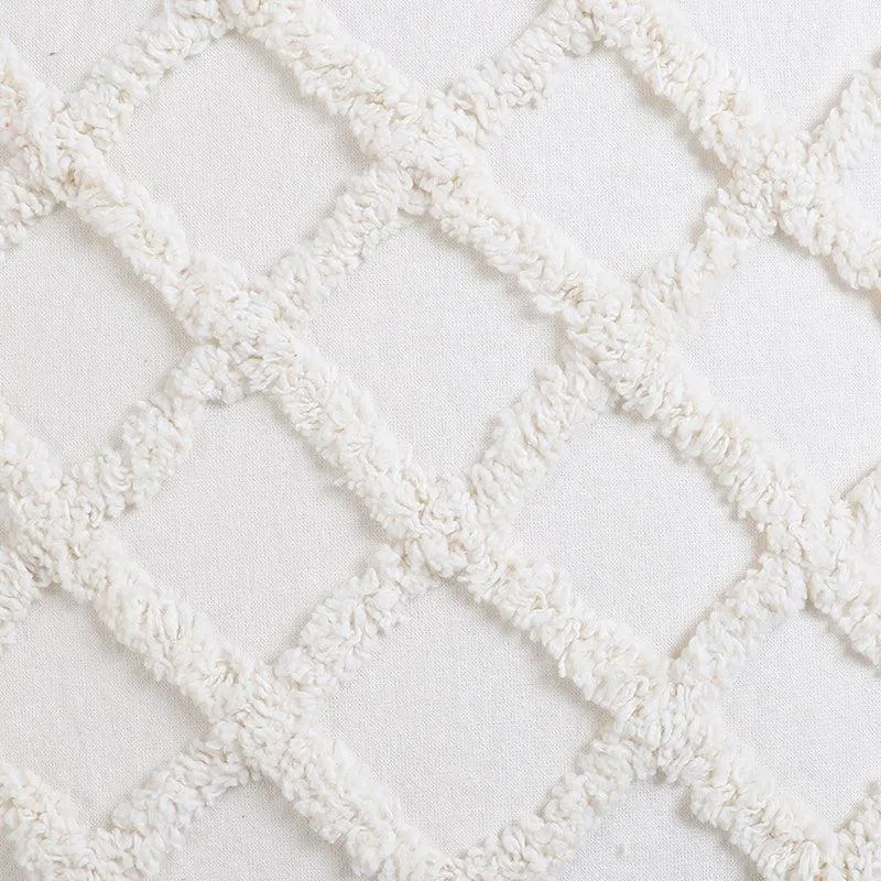 Close-up of the white tufted diamond pattern and fabric texture.