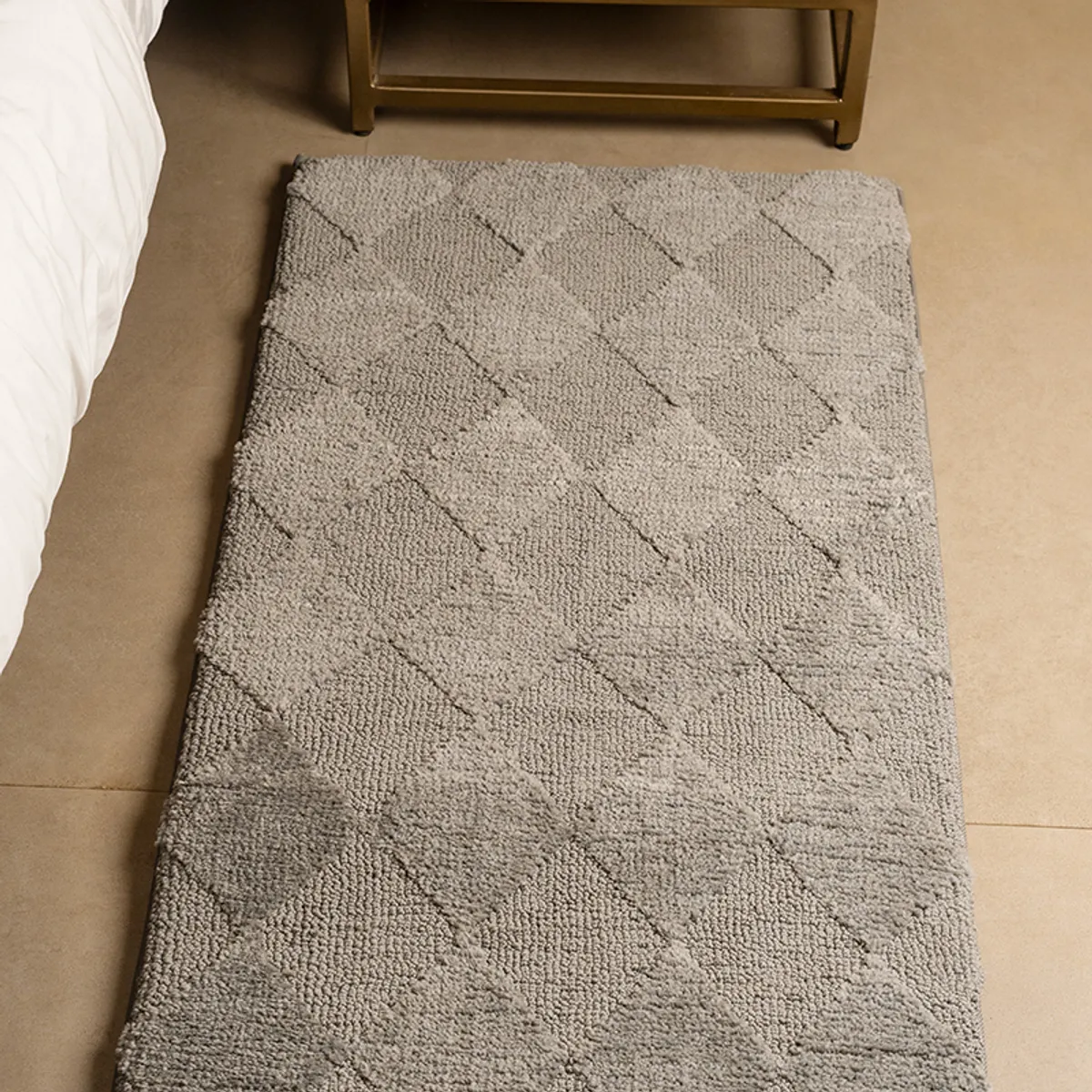 Close view of the grey runner's soft textured surface and diamond pattern
