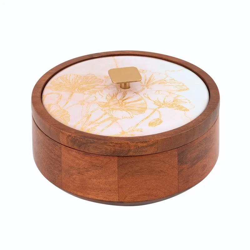 Angled view of round wooden masala box with cream floral lid