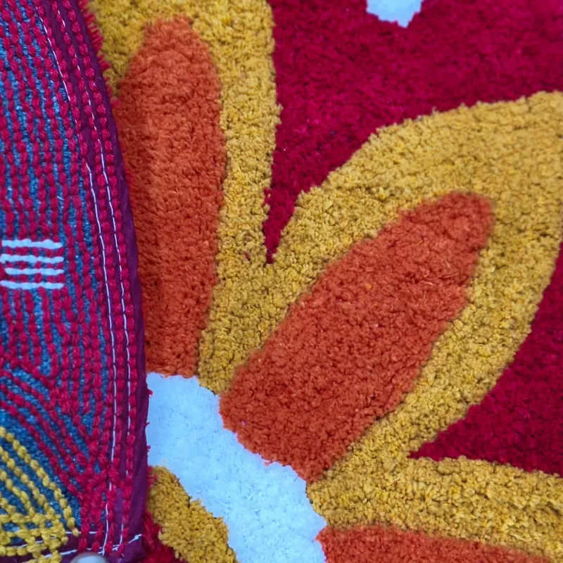 Close-up of the red, orange and yellow tufted floral surface