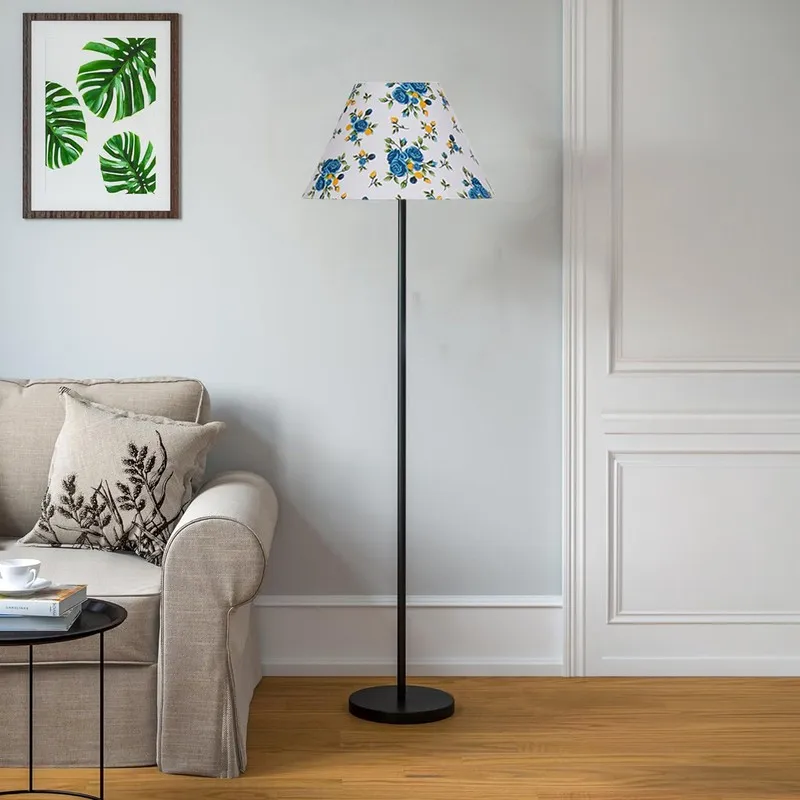 Blue floral shade floor lamp beside a cream sofa in a bright living room