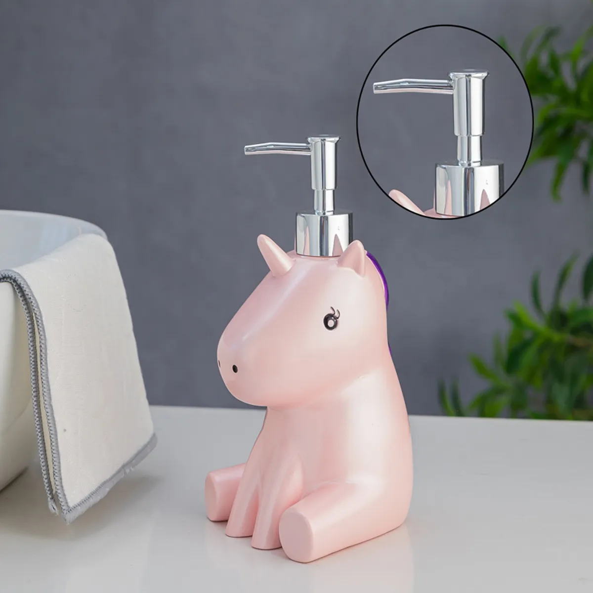 Pink unicorn soap dispenser with close-up inset of the pump