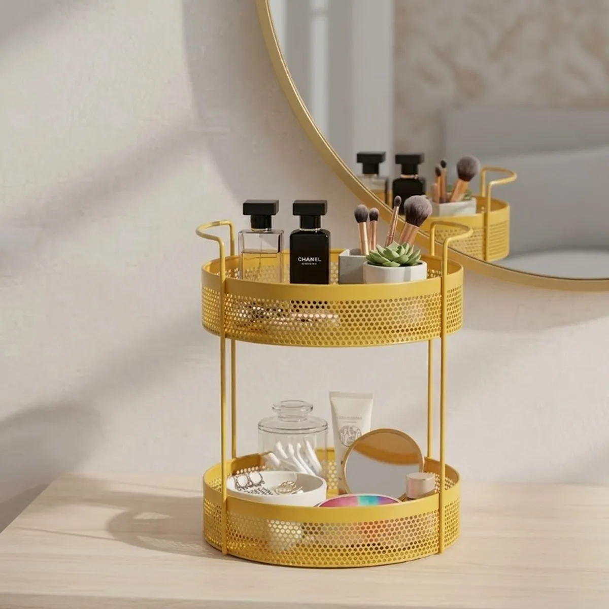 Yellow two-tier organiser holding beauty products and accessories on a vanity