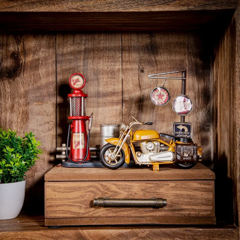 Wooden storage box with motorcycle and petrol station details in a wooden cabinet