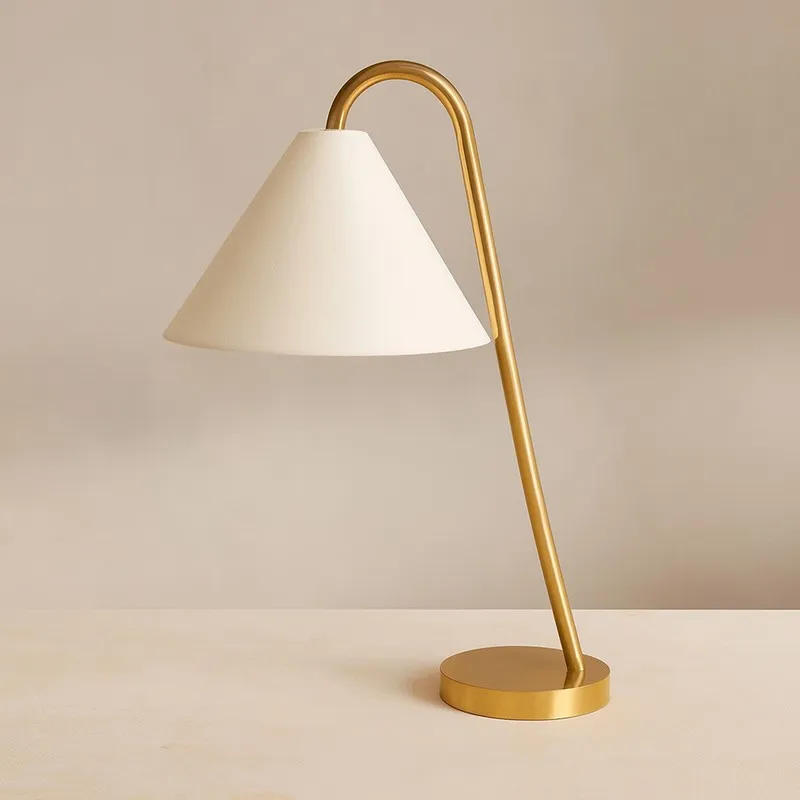 White and gold swan neck cotton table lamp on a plain backdrop