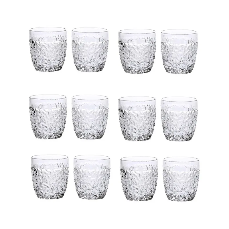 Set of twelve clear textured drinking glasses on a white background