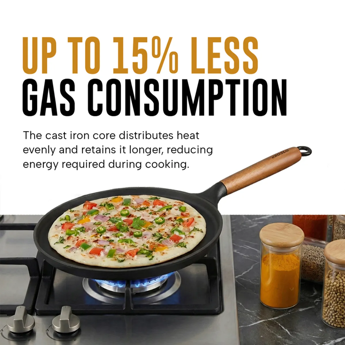 Black dosa tawa with a dosa cooking on a gas stovetop
