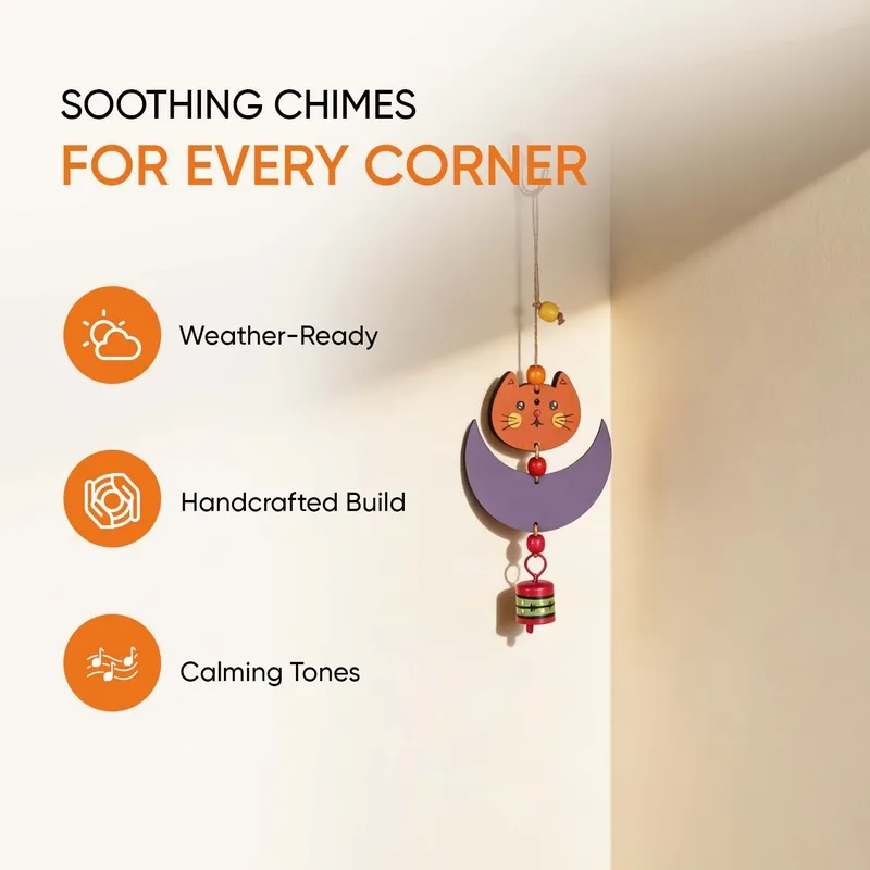 Cat-and-moon windchime shown hanging against a bright wall.