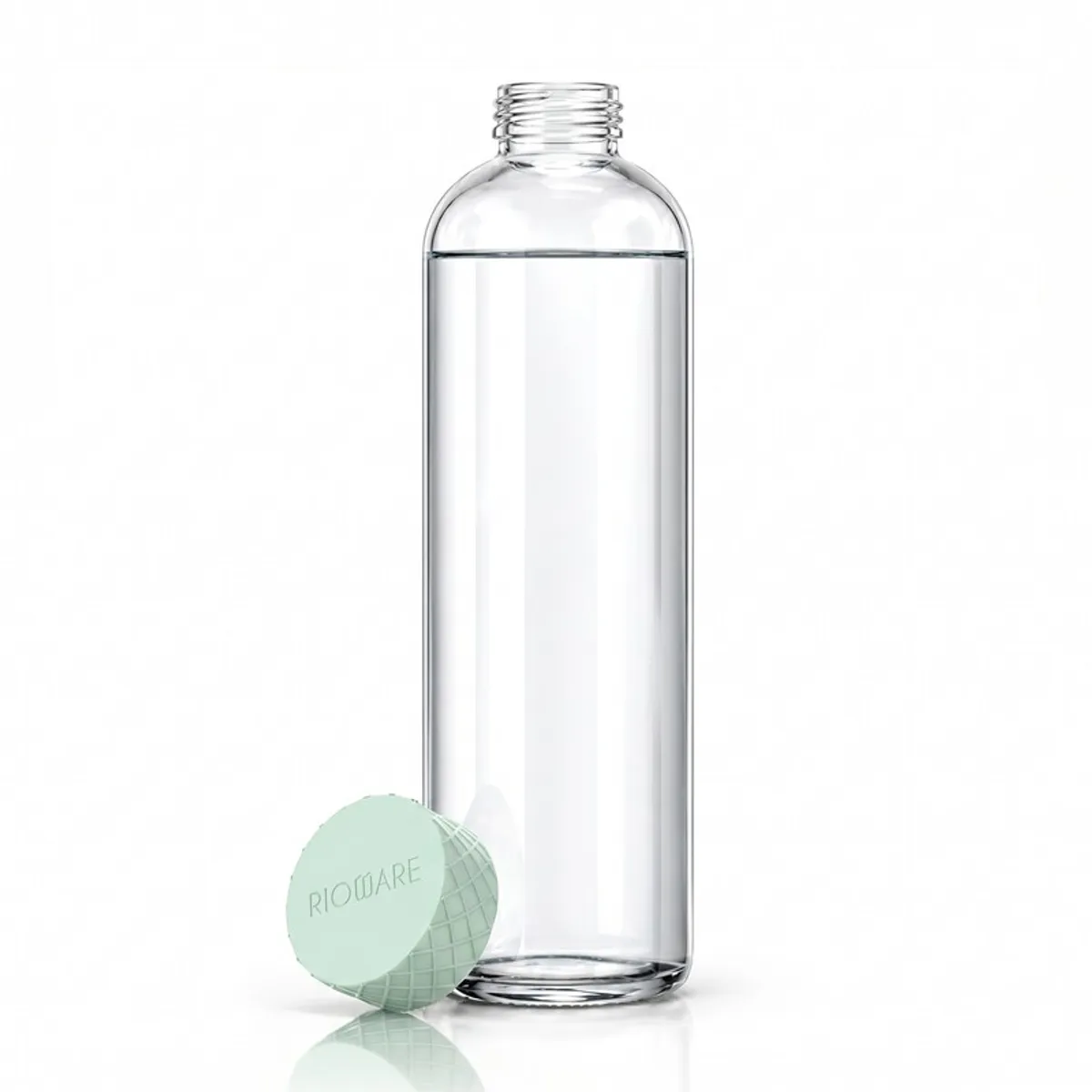 Open transparent glass water bottle beside its green textured cap.