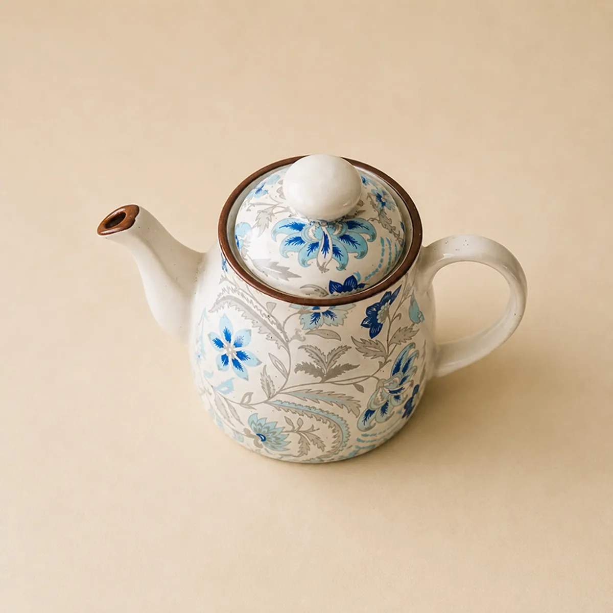 Close-up of the floral ceramic tea pot with lid and handle