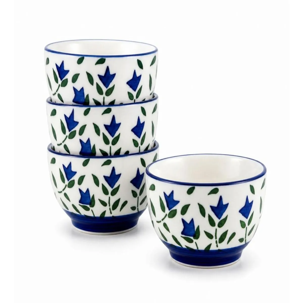 Four matching blue and white floral ceramic bowls stacked and displayed