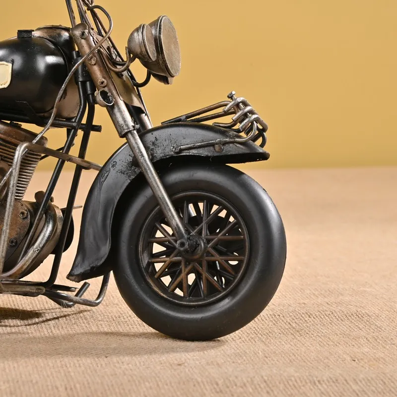 Close-up of the front wheel and headlamp area of the motorcycle showpiece