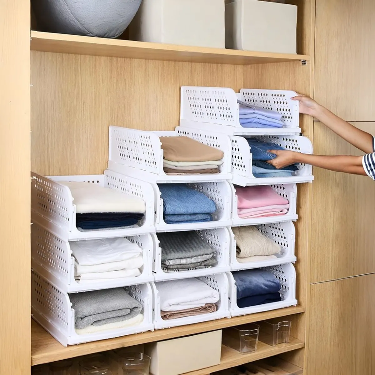 White organisers arranged in a wardrobe with folded clothes