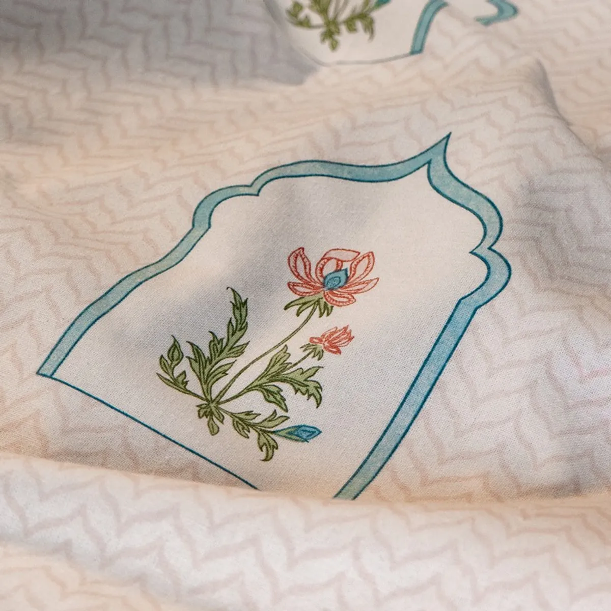 Close-up of soft pink patterned curtain fabric with floral motif