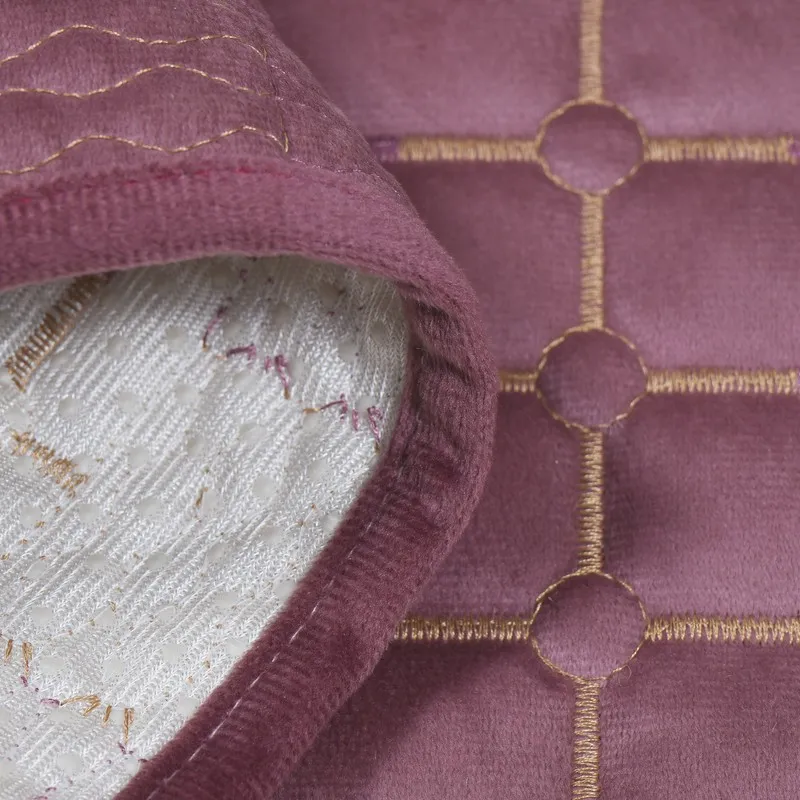 Close-up of the wine-purple velvet cover edge and geometric detailing