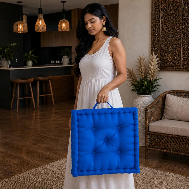 Person carrying a classic blue square floor cushion by its handle