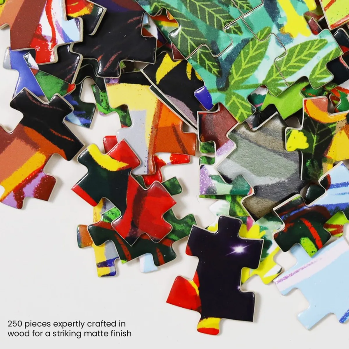 Close-up of loose multicolour puzzle pieces with botanical artwork